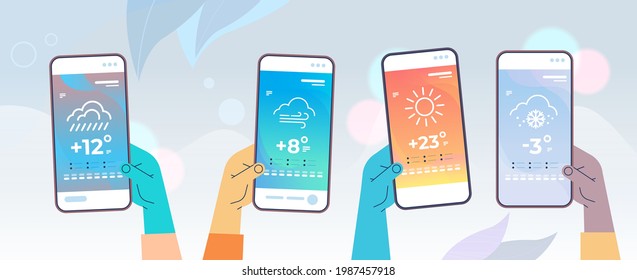 human hands holding smartphones with daily temperature mobile app weather forecasting and meteorology