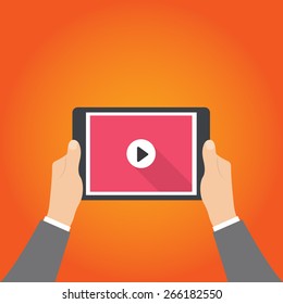 Human hands holding tablet computer with video player on the screen. Idea - Mobile collection of films, Cloud technologies for video collection.