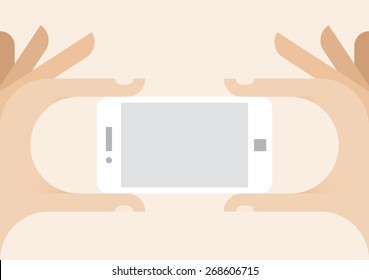 Human hands holding white mobile phone with blank screen for your text or information data.