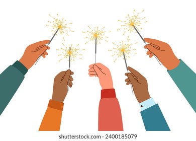 Human hands with sparklers raised upwards. Celebration concept.	