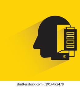 human head and battery with drop shadow yellow background