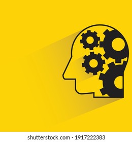 human head and cogwheels with shadow on yellow background