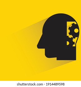 human head and gears with drop shadow yellow background