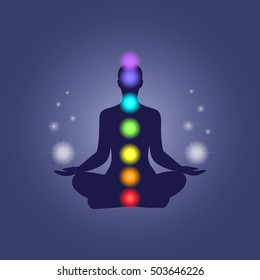 Human silhouette in yoga pose with chakras and spheres of light in hands.