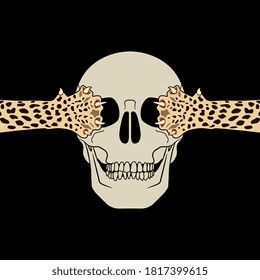 Human skull with two spotted feline paws covering its eye sockets. Creative concept.