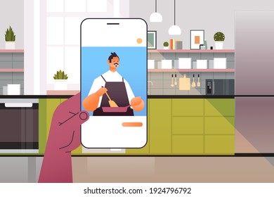 human watching chef food blogger preparing dish on smartphone screen online cooking concept kitchen interior portrait horizontal vector illustration