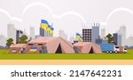 Humanitarian aid to refugees charity donation trucks and camp tents for sleep and volunteer the basic needs with Ukrainian flags