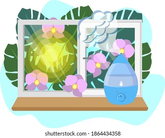 Un humidificador en el umbral de la ventana, y fuera del follaje de la ventana y las flores