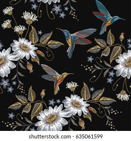 Humming bird and chamomile embroidery seamless pattern. Beautiful hummingbirds and white chamomile embroidery on black background. Template for clothes, textiles, t-shirt design 