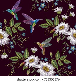 Humming bird and chamomile embroidery seamless pattern. Template for clothes, textiles, t-shirt design. Beautiful hummingbirds and white chamomile embroidery on black background 