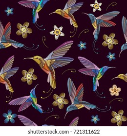 Humming bird and flowers embroidery seamless pattern. Beautiful hummingbirds and exotic flowers embroidery on black background. Template for clothes, textiles, t-shirt design 