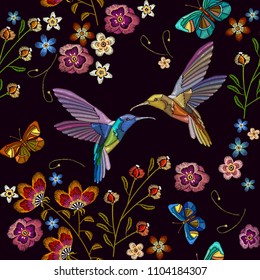 Humming bird and tropical flowers embroidery. Beautiful hummingbirds and exotic flowers on black background. Template for clothes, textiles, t-shirt design 