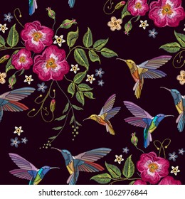 Humming birds and wild roses embroidery seamless pattern. Decorative floral embroidery fashion template for clothes, t-shirt design. Elegant flowers dogrose and tropical humming bird pattern 