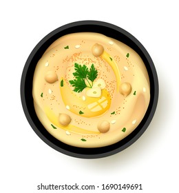 Hummus topped with whole chickpeas, olive oil, sesame, parsley, slices of garlic and sprinkled with paprika and greenery in black bowl with shadow isolated on white background. 