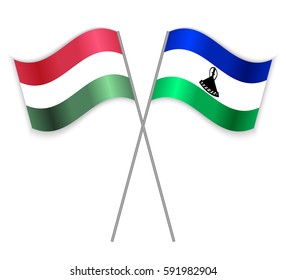 Hungarian and Basotho crossed flags. Hungary combined with Lesotho isolated on white. Language learning, international business or travel concept.