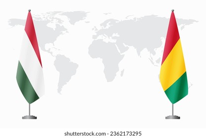 Hungary and Guinea flags for official meeting against background of world map.