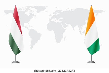 Hungary and Ivory Coast flags for official meeting against background of world map.