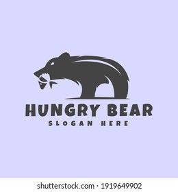 the hungry bear logo pressing the salmon. Suitable for fishing club logos or brands related to bears and fish, and suitable for illustration