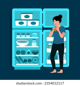 Hungry female standing in front of opened fridge eating food at night. Woman with night eating syndrome.