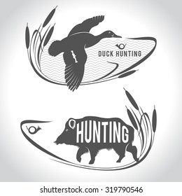 Hunting. Hunting Logo. Wild Boar And Wild Duck Over A Lake.