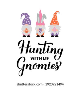 Hunting with my gnomies calligraphy hand lettering with cute gnomes holding eggs. Funny Easter quote typography poster.  Vector template for greeting card, banner, sticker, etc.