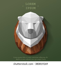 The hunting trophy on the wall. Bear head of polygons. Vector illustration