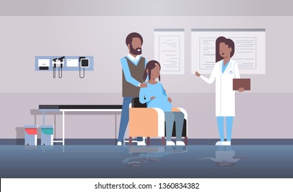 husband with pregnant wife visiting african american doctor gynecologist conducting pregnancy gynecology consultation concept modern hospital clinic interior full length horizontal