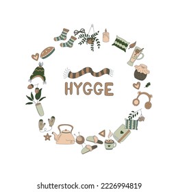Hygge. An armchair, a fireplace, warm clothes, hot drinks, a pie, autumn leaves and other things in the shape of a circle. Flat vector illustration in doodle style.