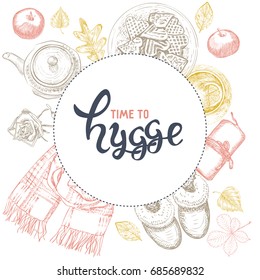 Hygge is a Danish living concept. Vector template with hand drawn illustrations cozy home things: candles, scarf, slippers, tea and cookies, autumn leaves, apples. Sketch style and lettering.