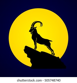 Ibex standing on the cliff designed on moonlight background graphic vector.