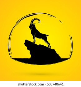 Ibex standing on the cliff graphic vector.