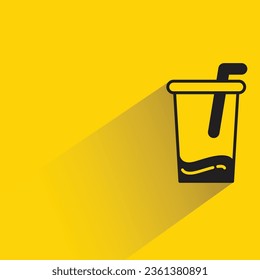 iced coffee with shadow on yellow background