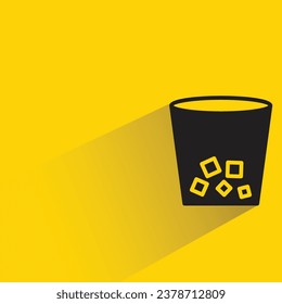 iced coffee with shadow on yellow background
