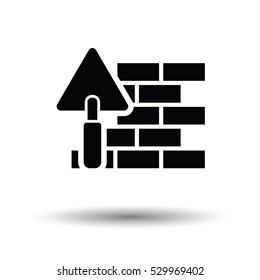 Icon of brick wall with trowel. White background with shadow design. Vector illustration.