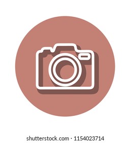 Icon of the contour of the camera with a shadow on a pink background of a circular shape