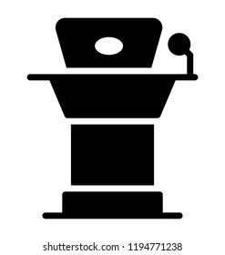 Icon of a desk having a laptop and mic depicting lecturer desk