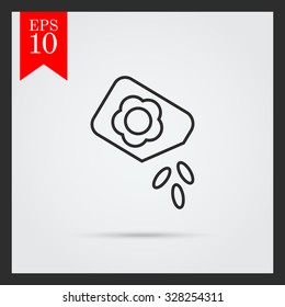Icon of flower seed packet with few seeds falling out