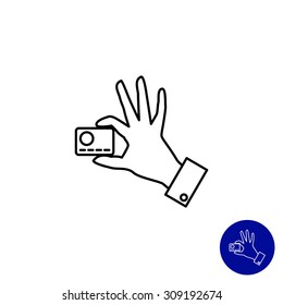Icon of man hand holding credit card with two fingers