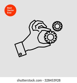 Icon of man hand holding two gear wheels