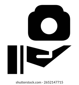 icon of an open hand holding a camera. Represents photography service, support, donation, sharing equipment, or media creation.