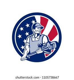 Icon retro style illustration of an American plumber and Pipefitter  holding monkey wrench with United States of America USA star spangled banner stars and stripes flag in circle isolated background.