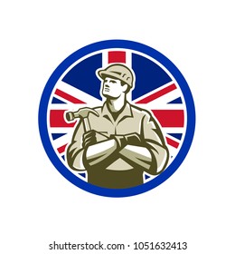 Icon retro style illustration of British builder, carpenter or construction worker with hammer arms crossed with United Kingdom UK, Great Britain Union Jack flag set inside circle isolated background.