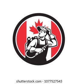 Icon retro style illustration of a Canadian welder or lit operator with visor holding welding torch with Canada maple leaf flag set inside circle on isolated background.
