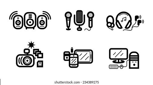 Icon set in black of digital gadgets with speakers, microphones, headphones, camera, smartphone, digital tablet, desktop computer isolated on white background