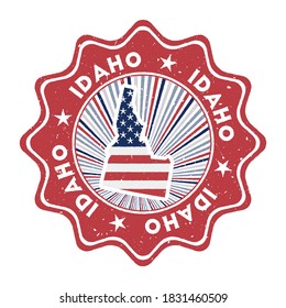 Idaho round grunge stamp with us state map and country flag. Vintage badge with circular text and stars, vector illustration.