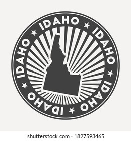 Idaho round logo. Vintage travel badge with the circular name and map of us state, vector illustration. Can be used as insignia, logotype, label, sticker or badge of the Idaho.