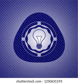 idea icon inside badge with denim background