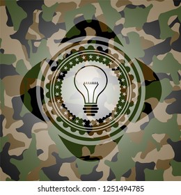 idea icon inside camouflage emblem