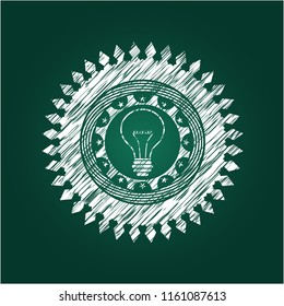 idea icon inside chalkboard emblem on black board