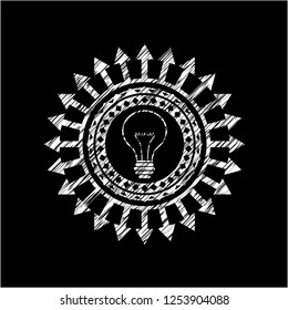 idea icon inside chalkboard emblem on black board